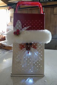 a bag with a santa clause on it sitting on top of a table next to a red handle