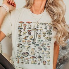 Introducing our beautiful Mushroom Identification t-shirt, the perfect addition to any mushroom hunter's wardrobe! Made from soft and breathable fabric, this t-shirt features a vintage mushroom educational graphic with the name of each mushroom translated into English and common name.  Wear it on a hike, forest foraging or simply while running errands and let your love of this beautiful fungi be known!   This Comfort Colors medium-weight t-shirt is made from premium 100% cotton material, chosen Graphic Tee Shirt With Mushroom Print, Relaxed Fit Graphic Tee With Mushroom Print, White Mushroom Print Short Sleeve Top, Mushroom Print Cotton Top For Streetwear, Casual White Shirt With Mushroom Print, White Short Sleeve Tops With Mushroom Print, White Short Sleeve Top With Mushroom Print, Cotton Mushroom Print Top For Streetwear, Cotton Top With Mushroom Print For Streetwear