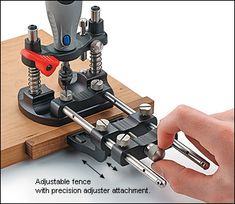 a person is working on a piece of wood with tools attached to the machine and screws