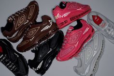 five pairs of nike air max sneakers in various colors and sizes on a gray surface