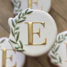 decorated cookies with the letter e and leaves on them are shown in close - up