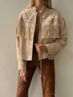 *Product size on mannequin Small, UK:8 - US:6Women's Pure Beige Denim Fringe Jacket * It is the SMALL size on the model. The model's height is 175 and it weighs 55 kilos. * The length of the jacket from the shoulder down is 55 cm. * Regular cut * This jacket is exactly made of Premium denim fabric. has been carefully * We designed and produced with attention to all details. * Perfect Design, professional cut and First class stitching * According to international standards throughout. * Ideal for Spring Rodeo Outerwear With Fringe, Bohemian Long Sleeve Outerwear For Rodeo, Fitted Beige Outerwear For Festivals, Cream Fringe Outerwear For Spring, Spring Long Sleeve Denim Jacket For Rodeo, Spring Cream Outerwear With Fringe, Spring Rodeo Long Sleeve Denim Jacket, Spring Cream Fringe Outerwear, Beige Festival Outerwear For Spring