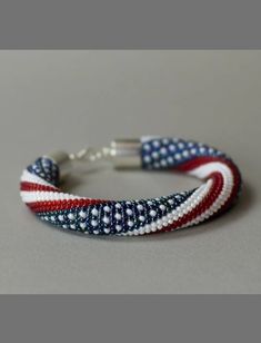 an american flag bracelet on a gray surface