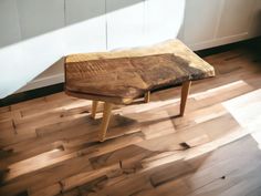 a wooden bench sitting on top of a hard wood floor