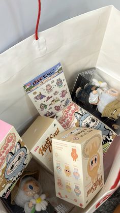 an open box with some toys inside of it on a table next to other items