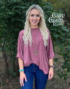 Unleash the power of the fresh Lucky & Blessed Dolman Top featuring cuffed sleeves -ultra-stretch fabric that's both cozy and wrinkle-proof! Ideal for any event, this top exudes an oversized flair and is available in an array of stunning holiday-inspired shades. Elevate your closet today and experience pure awesomeness in this essential top! Trendy Rolled Sleeve Blouse For Fall, Fall Tops With Rolled Long Sleeves, Fall Tops With Cuffed Sleeves And Relaxed Fit, Spring Solid Tops With Cuffed Sleeves, Fall Short Sleeve Tops With Rolled Sleeves, Casual Tops With Cuffed Sleeves For Fall, Fall Tops With Rolled Sleeves And Short Sleeve, Oversized Tops With Cuffed Sleeves For Spring, Fall Blouse With Rolled Sleeves