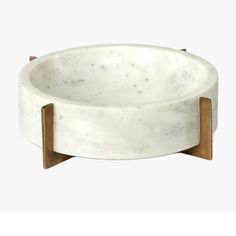 a white marble bowl with wooden legs on a white background, it looks like an object that has been made out of wood