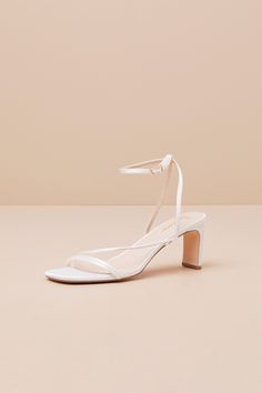 Keep things chic and simple by adding the Lulus Kierha White Satin Strappy Low Heel Sandals to any of your effortlessly elegant 'fits! Sleek woven satin shapes these darling heels that feature a square footbed and a trio of slender straps that cross the vamp. A matching strap wraps the front of the ankle and secures with a gold buckle, all atop a trendy blade heel. 2. 75" wrapped blade heel. Cushioned insole. Felted rubber sole has nonskid markings. Man made materials. Imported. Lulus | Kierha W Padded Heel Summer Wedding Shoes, Summer Evening Wedding Shoes With Padded Heel, Summer Sandals With Padded Heel For Wedding Guest, Elegant Kitten Heels With Heel Loop For Spring, Low Heel Satin Wedding Shoes For Summer, Elegant Sandals With Wrapped Heel And Medium Width, Summer Heels With Heel Strap For Wedding Guest, Summer Wedding Guest Heels With Heel Strap, Elegant Summer Wedding Shoes With Heel Strap