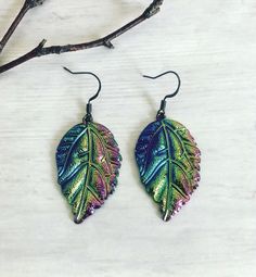 "Rainbow Metallic Leaf Stainless Steel Earrings Earrings Size: Approximately 1.5\" Rainbow Metallic finished made over brass The color changes at different angles or light reflections Materials: Stainless Steel Nickel Free Lightweight Please visit my shop for listings" Multicolor Leaf Shaped Earrings Gift, Multicolor Leaf Earrings For Gift, Multicolor Leaf Earrings Gift, Multicolor Leaf-shaped Earrings For Gift, Rainbow Crystal Bracelet, Pride Bracelet, Rainbow Crystal, Rainbow Earrings, Steel Earrings