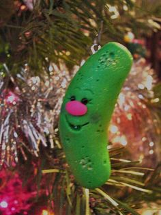 a pickle ornament hanging from a christmas tree