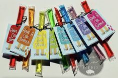 there are many different colored candy sticks with tags on them that say have cool summer