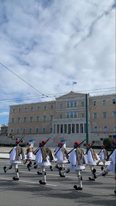 a group of people that are on some kind of skateboard in front of a building