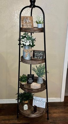 three tiered shelf with flowers and signs on it