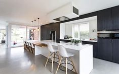 a kitchen with black cabinets and white countertops is seen in this image from the front view