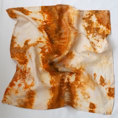 a burnt piece of cloth on a white surface