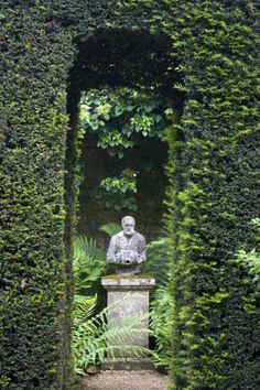 a statue in the middle of a garden