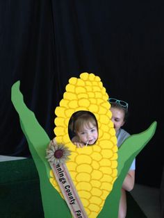 two children in a cardboard corn on the cob costume