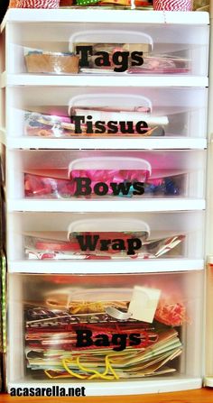 the drawers are organized and labeled with tags, tissue, bows, wraps, bags