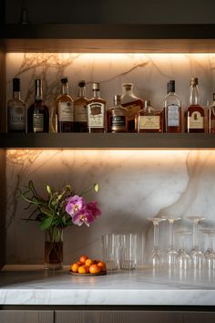 bottles and glasses are lined up on the counter