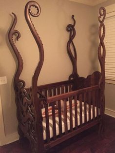 an ornate wooden crib in a bedroom