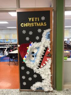 a door decorated to look like a dragon with christmas decorations on it and the words yeti christmas