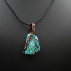 A lovely blue Turquoise pendant wire wrapped in antiqued copper. This turquoise has been shaped into a unique freeform style insiped by the natural shape of the stone and beautifully wire wrapped in a way to flow withe the natural pattern of the stone. Handmade by us. Stone shaping was done by Sean. Wire wrapping was done by Janet. This pendant weighs 6 grams. Measures 0.75" wide  1.5" tall. Necklace in photos included. Wire Wrapped Turquoise, Copper Pendant, Bleu Turquoise, Copper Pendants, Patterns In Nature, Natural Shapes, Turquoise Pendant, Blue Turquoise, Antique Copper