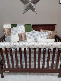 a baby crib with several pillows on it and a star above the crib