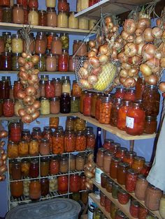 a bunch of jars filled with food sitting on top of shelves