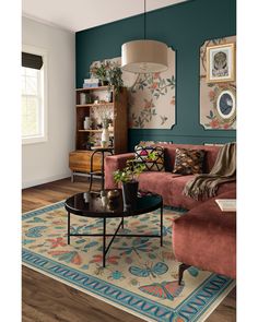 a living room filled with furniture and decor on top of a hard wood floored floor