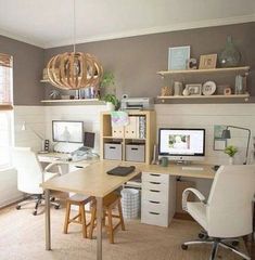 a home office with two computer desks and shelves