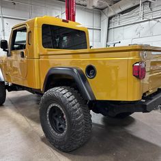 a large yellow truck parked in a garage