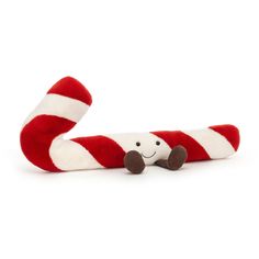 a red and white striped candy cane with a smiling face on it's side