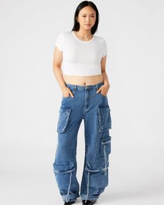 Expertly designed for a structured and voluminous fit, the DUO medium denim pant is crafted from midweight cotton twill fabric. With adjustable ankle straps, these wide leg cargo pants offer a versatile silhouette that can be easily customized to your preference. Mid rise cargo pants Zipper fly with shank button closure Two side pockets, two back patch pockets, and five cargo pockets down the legs Bottom 3 cargo pockets feature extended zipper pulls Snap strap at hem to cinch ankles Inseam: 31" Wide Leg Cargo Pants, Denim Pants Women, Shank Button, Zipper Pulls, Dress With Sneakers, Twill Fabric, Bottom Clothes, Ankle Straps, Denim Pant