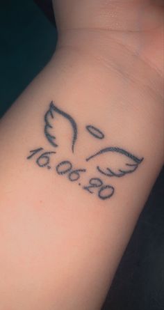 a close up of a person's wrist with a tattoo on it