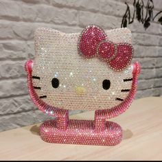 a hello kitty figurine made out of swaroons on a wooden table