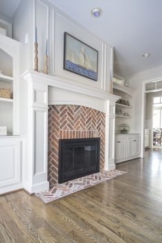 a living room with a fire place in the center and shelves on either side of the fireplace