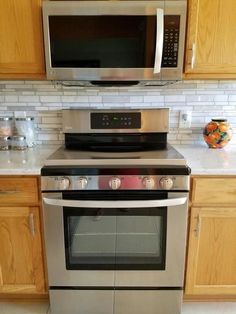 a stainless steel oven and microwave in a kitchen