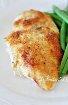 a white plate topped with meat and green beans