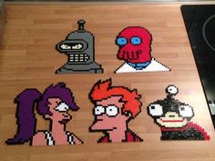 the pixel art is made to look like cartoon character heads and headphones on a wooden surface