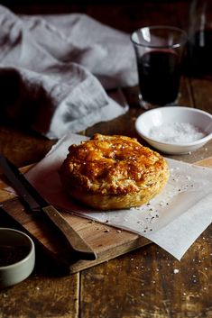 a pastry sitting on top of a wooden cutting board