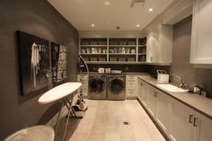 a washer and dryer in a very large room with lots of counter space