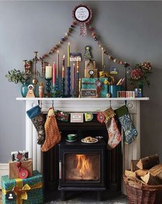 a fireplace with stockings and candles on it