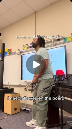 a man standing in front of a white board