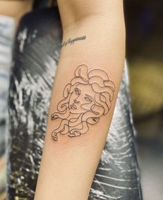 a woman with a tattoo on her arm