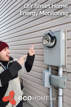 a man pointing at an energy monitoring device