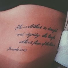 the back of a woman's stomach with a bible verse tattooed on it