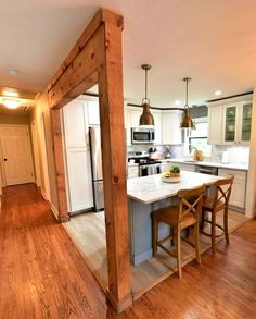 an open concept kitchen and dining room with wood floors