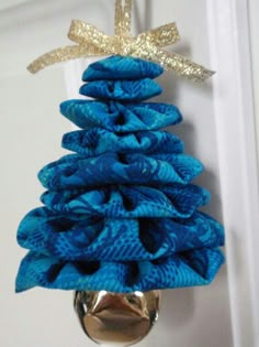 a blue christmas tree ornament hanging from a door