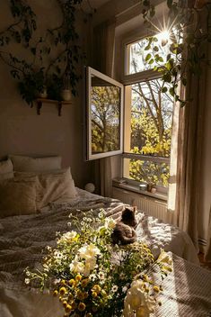 there is a bed with flowers on it and a teddy bear in the window sill