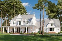 a large white house surrounded by trees and grass